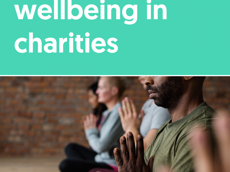 Front cover of report showing the title and a group of people sat with legs crossed and hands together. It reads: Workforce wellbeing in charities Maisie Hulbert, November 2020 Logos of ACEVO and Mental Health Foundation England