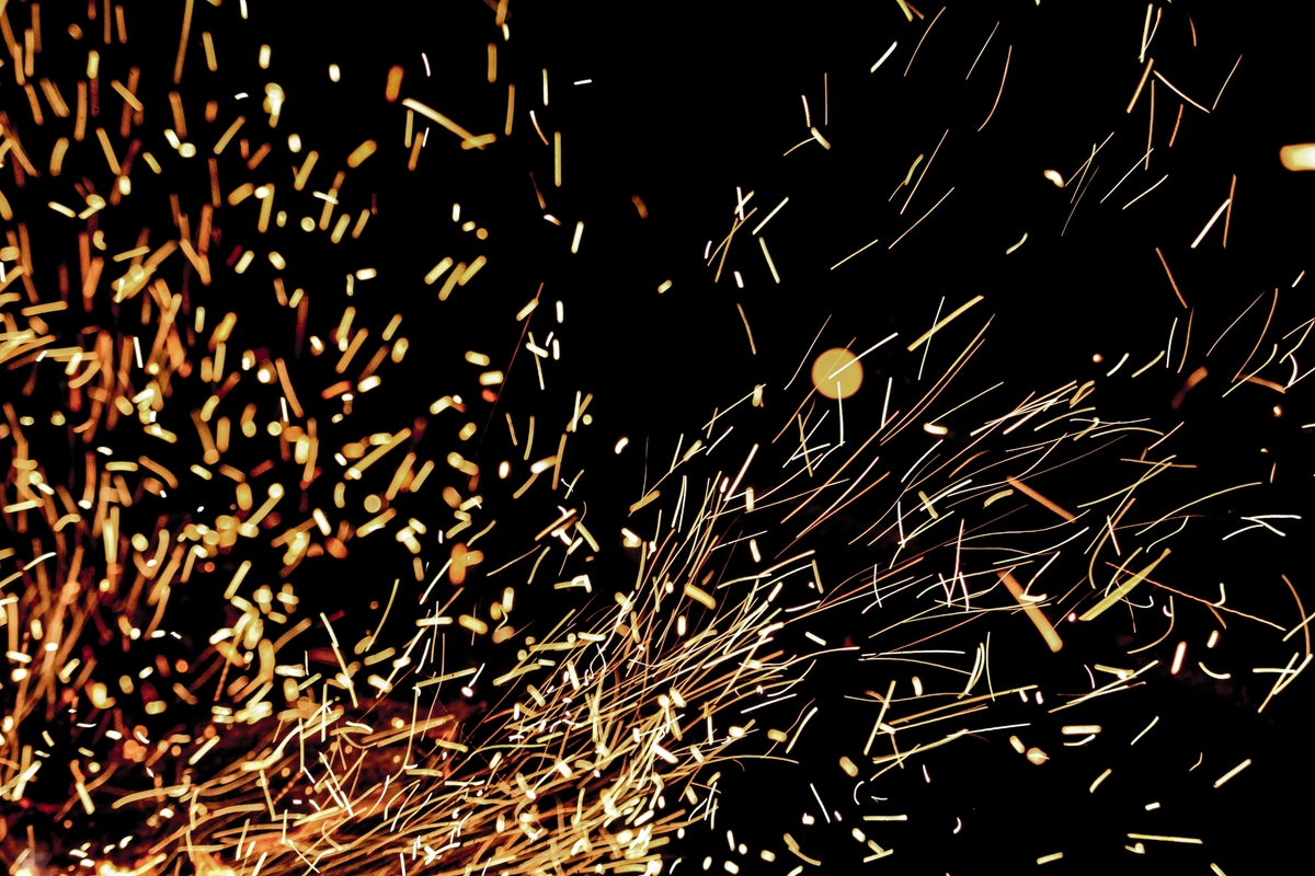 sparkles from a firepit against a dark background